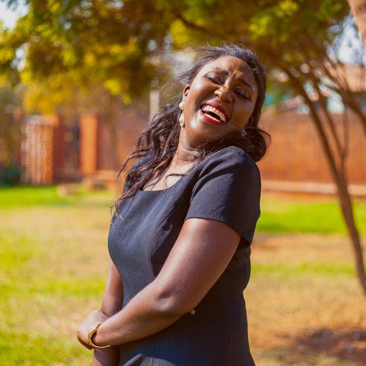 Avery Singh, Lead Design Curator at Anchor Garden Silent, reviewing corporate floral arrangements